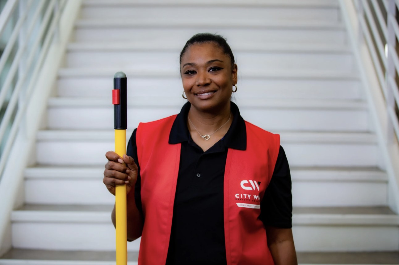 City Wide crew member holding a mop handle